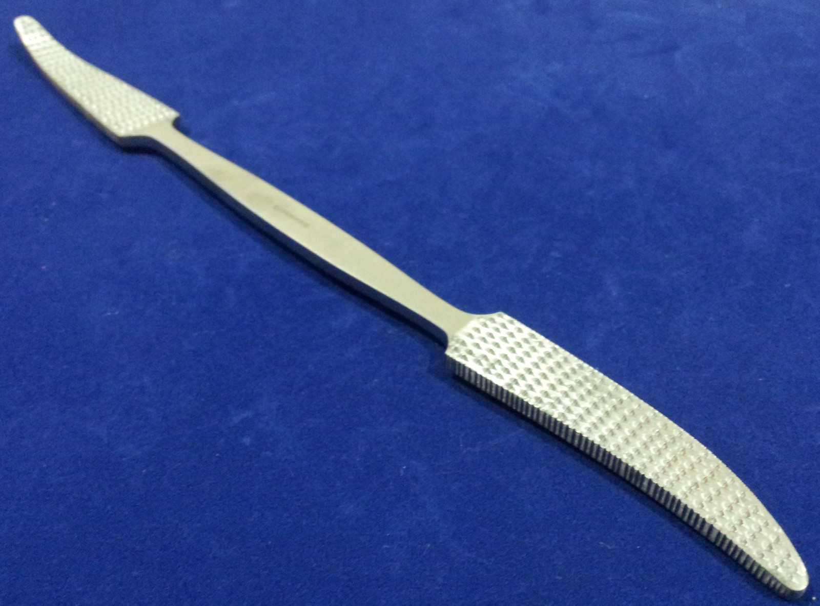 O.R GRADE PUTTI BONE RASP 11″, ONE SIDE CURVED ON FLAT ,OTHER CURVED SIDEWAYS