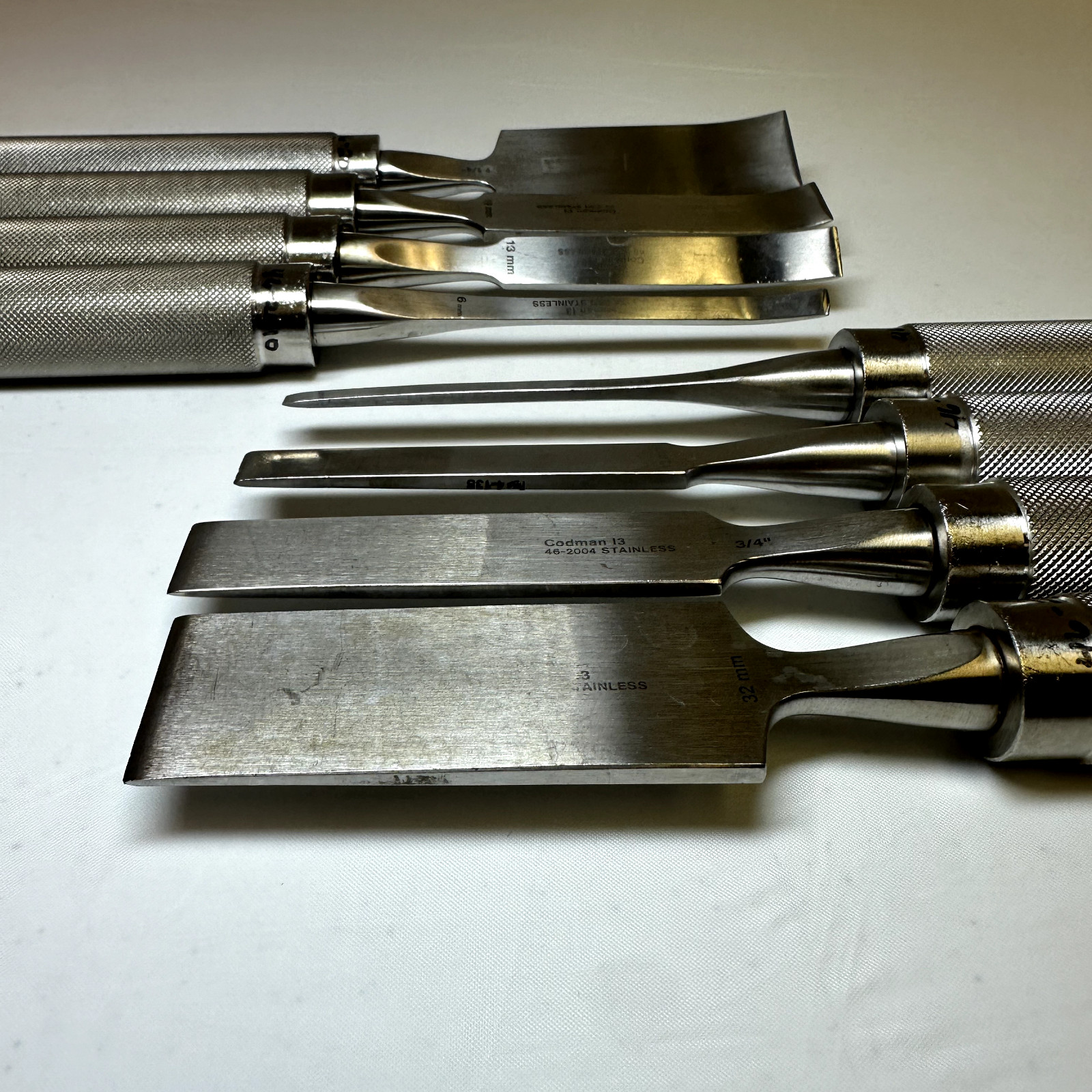 Set of 8 Codman OptiLength 11″ Straight & Curved Osteotomes w/ Case Orthopedics