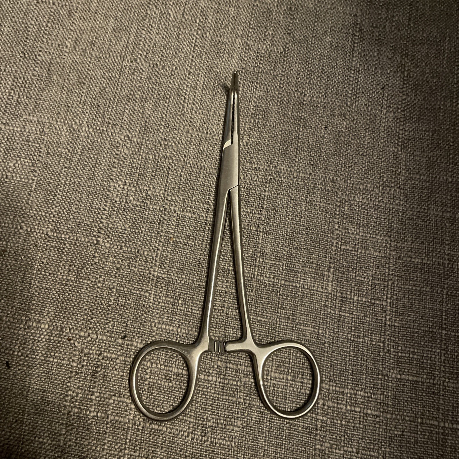 surgical nerve hook or dissecting hook. Hemostat